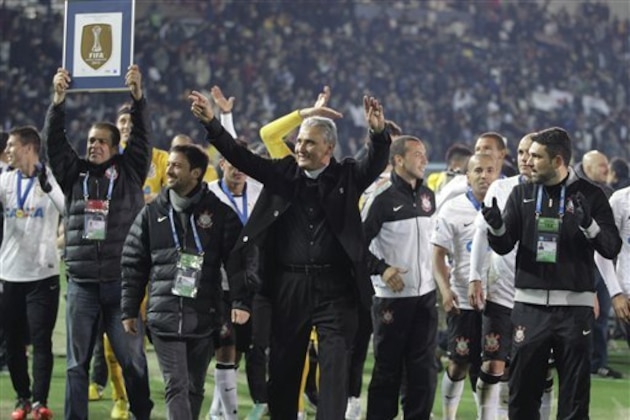 Corinthians' coach Tite, center, and team members celebrate following an award ceremony after beating Chelsea FC 1-0 in their final match to win the FIFA Club World Cup soccer tournament in Yokohama, near Tokyo, Sunday, Dec. 16, 2012. (AP Photo/Shizuo Kambayashi)