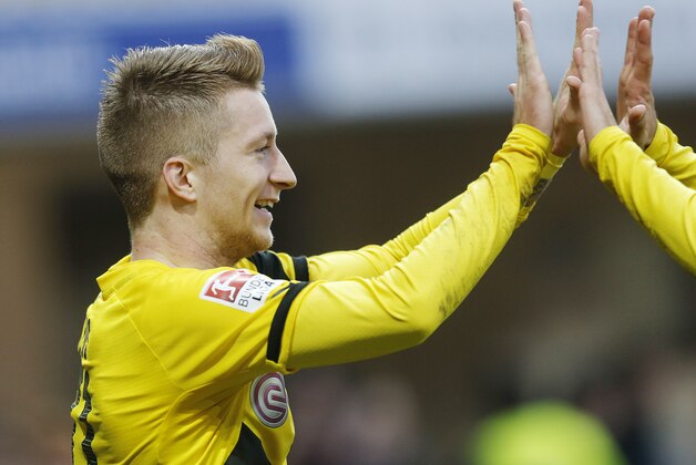 Dortmund's Marco Reus celebrates his side's second goal during the German first division Bundesliga soccer match between SC Paderborn 07 and Borussia Dortmund in Paderborn, Germany, Saturday, Nov. 22, 2014. (AP Photo/Michael Probst)