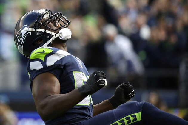 Seattle Seahawks defensive end Cliff Avril reacts after he sacked Arizona Cardinals quarterback Drew Stanton in the first half of an NFL football game, Sunday, Nov. 23, 2014, in Seattle. (AP Photo/Elaine Thompson)