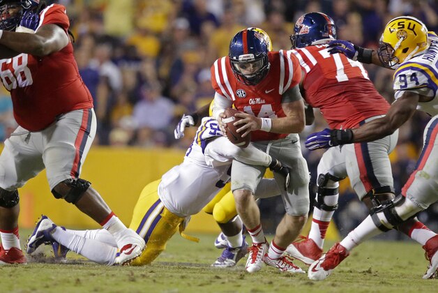 Mississippi quarterback Bo Wallace (14) is sacked in the second half of an NCAA college football game against LSU in Baton Rouge, La., Saturday, Oct. 25, 2014. (AP Photo/Gerald Herbert)
