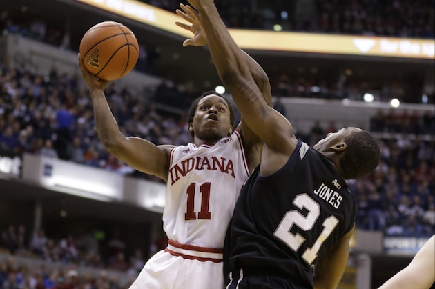 Indiana guard Yogi Ferrell, left, shoots over Butler forward Roosevelt Jones in the second half of an NCAA college basketball game in Indianapolis, Saturday, Dec. 15, 2012. Butler defeated Indiana 88-86 in overtime. (AP Photo/Michael Conroy)