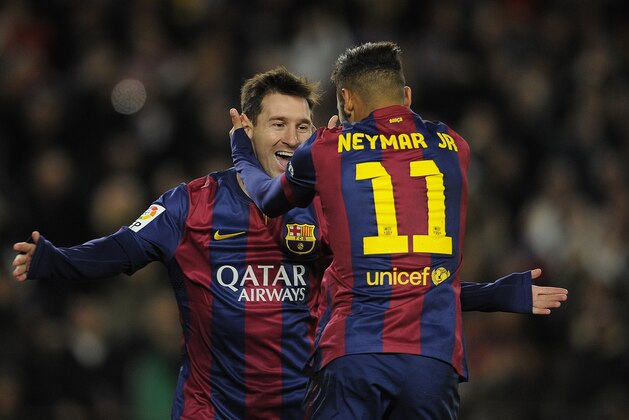 FC Barcelona's Lionel Messi, from Argentina, left, reacts after scoring with his teammate Neymar, from Brazil, during a Spanish La Liga soccer match against Espanyol at the Camp Nou stadium in Barcelona, Spain, Sunday, Dec. 7, 2014. (AP Photo/Manu Fernandez)