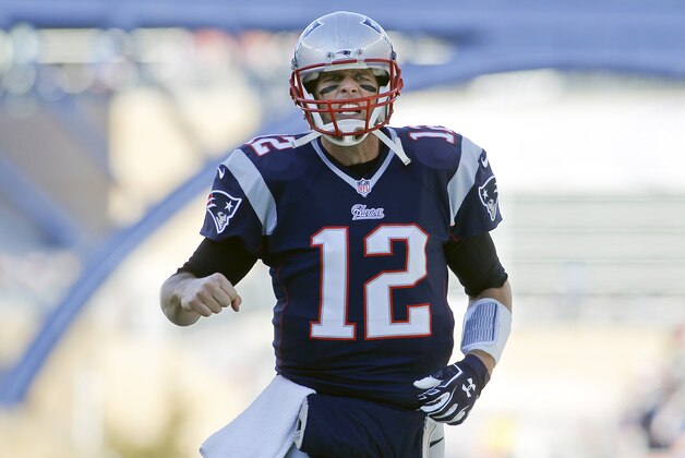 Dec 14, 2014; Foxborough, MA, USA; New England Patriots quarterback Tom Brady (12) runs onto the field prior to the Patriots' game against the Miami Dolphins at Gillette Stadium. Mandatory Credit: Stew Milne-USA TODAY Sports