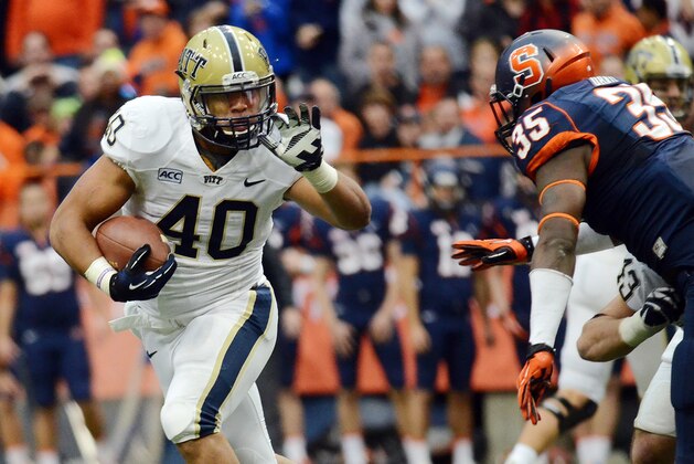 Pittsburgh's James Connor, left, attempts to carry the ball past Syracuse's Dyshawn Davis during an NCAA college football  game at the Carrier Dome in Syracuse, N.Y., Saturday, Nov. 23, 2013.  (AP Photo/Heather Ainsworth)