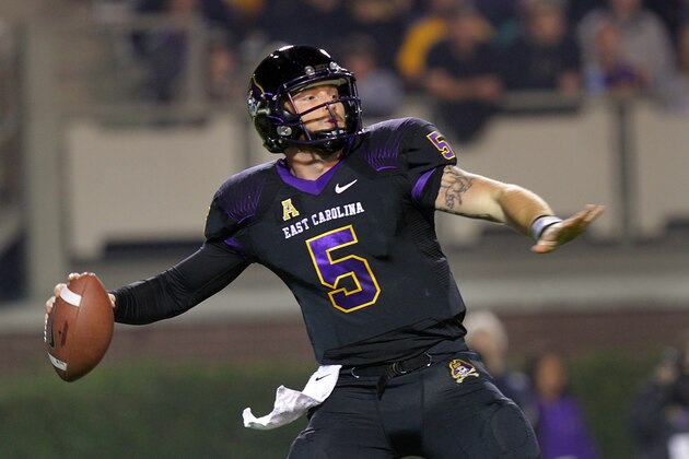 East Carolina quarterback Shane Carden (5) prepares to launch a pass against Connecticut during an NCAA college football game in Greenville, N.C., Thursday, Oct. 23, 2014. (AP Photo/Ted Richardson)