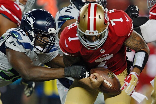 SANTA CLARA, CA - NOVEMBER 27: Quarterback Colin Kaepernick #7 of the San Francisco 49ers nearly loses the ball as he is sacked by defensive end Cliff Avril #56 of the Seattle Seahawks in the first quarter on November 27, 2014 at Levi's Stadium in Santa Clara, California.  The Seahawks won 19-3. (Photo by Brian Bahr/Getty Images)