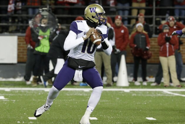 Washington quarterback Cyler Miles passes against Washington State in the first half of an NCAA college football game, Saturday, Nov. 29, 2014, in Pullman, Wash. (AP Photo/Ted S. Warren)