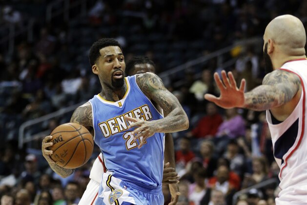 Denver Nuggets' Wilson Chandler, left, dribbles the ball toward Atlanta Hawks' Pero Antic, right, of Macedonia, in the third quarter of an NBA basketball game, Sunday, Dec. 7, 2014, in Atlanta. Atlanta won 96-84. (AP Photo/David Goldman)