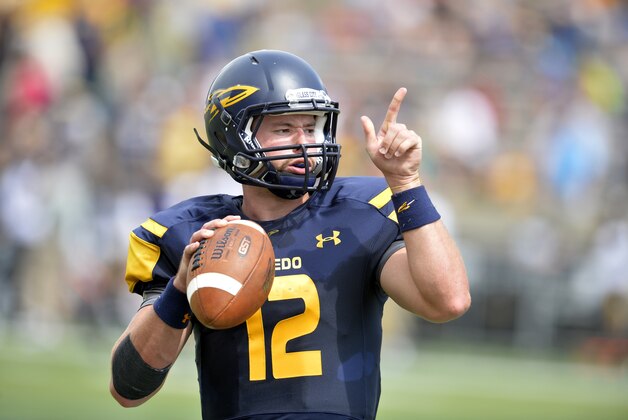 Toledo Rockets quarterback Phillip Ely (12) warms up at halftime of a 49-24 loss to the Missouri Tigers in an NCAA college football game in Toledo, Ohio, Saturday, Sept. 6, 2014. (AP Photo/David Richard)