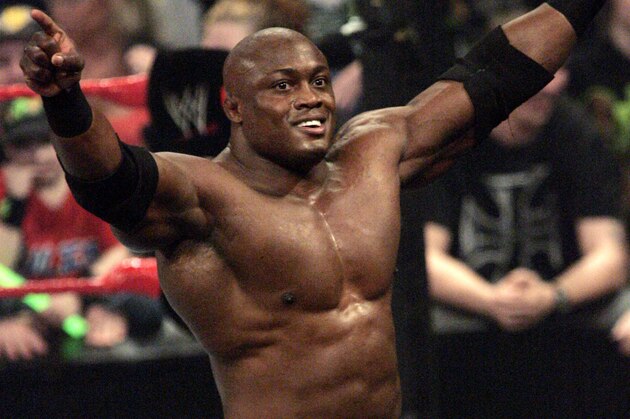 FILE - In this March 19, 2007, file photo, then-WWE wrestler Bobby Lashley celebrates after defeating Chris Masters during a match at WWE Monday Night Raw in Indianapolis. Lashley is no Brock Lesnar. But the TNA Wrestling heavyweight champion hopes his shift to Bellator can give a boost to both second-tier promotions. Lashley has one of the featured bouts on Friday night when Bellator goes head-to-head on national TV vs. UFC.(AP Photo/Tom Strattman, File)