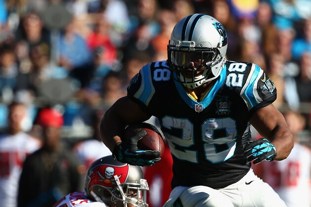 CHARLOTTE, NC - DECEMBER 14:  Jonathan Stewart #28 of the Carolina Panthers runs from  Da'Quan Bowers #91 of the Tampa Bay Buccaneers in the 1st quarter during their game at Bank of America Stadium on December 14, 2014 in Charlotte, North Carolina.  (Photo by Streeter Lecka/Getty Images)