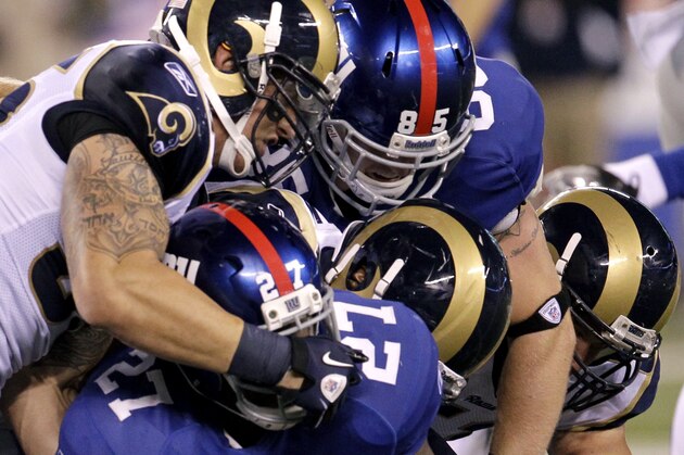 New York Giants' Brandon Jacobs (27) is tackled during the fourth quarter of an NFL football game against the St. Louis Rams Monday, Sept. 19, 2011, in East Rutherford, N.J. (AP Photo/Julio Cortez)