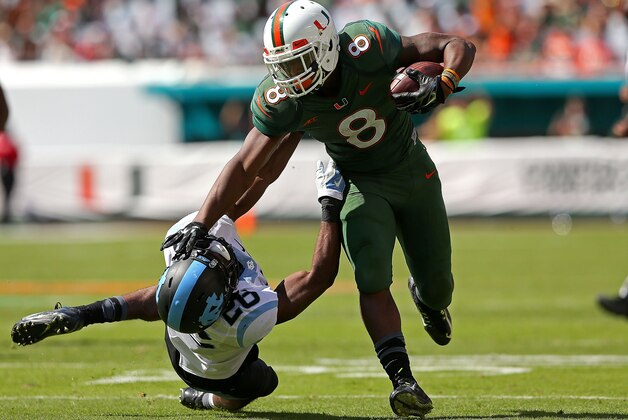 MIAMI GARDENS, FL - NOVEMBER 01:  Duke Johnson #8 of the Miami Hurricanes rushes for a first down during a game against the North Carolina Tar Heels at Sun Life Stadium on November 1, 2014 in Miami Gardens, Florida.  (Photo by Mike Ehrmann/Getty Images)