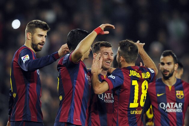 FC Barcelona's Lionel Messi, third left, celebrates with teammates after scoring against Cordoba during a Spanish La Liga soccer match at the Camp Nou stadium in Barcelona, Spain, Saturday, Dec. 20, 2014. (AP Photo/Manu Fernandez)