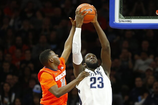 PHILADELPHIA, PA - DECEMBER 20: Daniel Ochefu #23 of the Villanova Wildcats grabes a rebound as he fights off Kaleb Joseph #14 of the Syracuse Orange during the first half of an NCAA college basketball game on December 20, 2014 at the Wells Fargo Center in Philadelphia, Pennsylvania. (Photo by Rich Schultz /Getty Images)