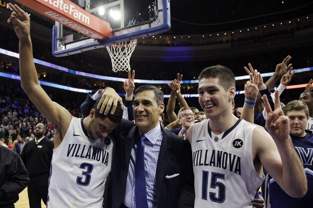 Villanova head coach Jay Wright, center, celebrates with Josh Hart, left, and Ryan Arcidiacono after an NCAA college basketball game against Syracuse, Saturday, Dec. 20, 2014, in Philadelphia. Villanova won 82-77 in overtime. (AP Photo/Matt Slocum)