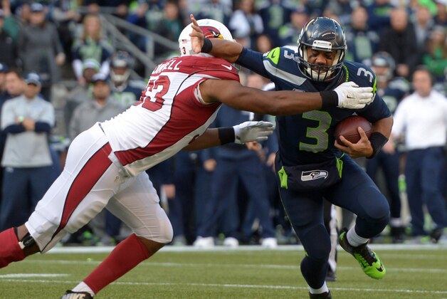 Nov 23, 2014; Seattle, WA, USA; Seattle Seahawks quarterback Russell Wilson (3) is pressured by Arizona Cardinals defensive tackle Calais Campbell (93) at CenturyLink Field. Mandatory Credit: Kirby Lee-USA TODAY Sports
