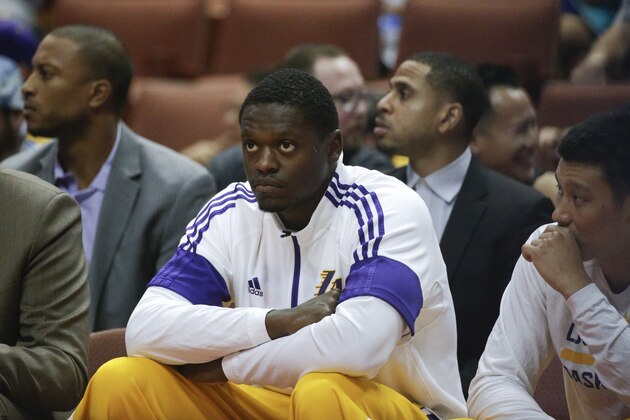 Los Angeles Lakers' Julius Randle sits on the bent during the first half of a preseason NBA basketball game against the Phoenix Suns on Tuesday, Oct. 21, 2014, in Anaheim, Calif. (AP Photo/Jae C. Hong)