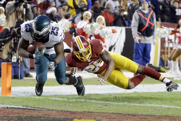 Philadelphia Eagles running back LeSean McCoy (25) carries the ball into the end zone for a touchdown under pressure from Washington Redskins cornerback Bashaud Breeland (26) during the first half of an NFL football game in Landover, Md., Saturday, Dec. 20, 2014. (AP Photo/Patrick Semansky)