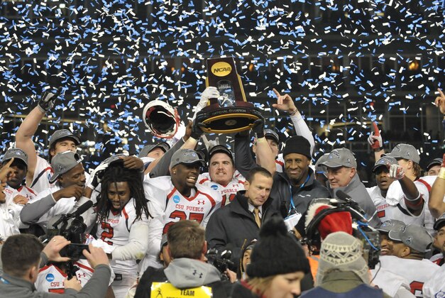 Dec 20, 2014; Kansas City, MO, USA; Colorado State Pueblo Thunderwolves center Scotland Coyle (71) hoists the championship trophy as players celebrate after the game against the Minnesota State Mankato Mavericks at Sporting Park. Colorado State won 13-0. Mandatory Credit: Denny Medley-USA TODAY Sports