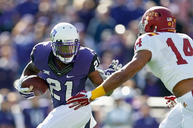 FORT WORTH, TX - DECEMBER 06:  Running back Kyle Hicks #21 of the TCU Horned Frogs rushes the football against linebacker Jared Brackens #14 of the Iowa State Cyclones during the Big 12 college football game at Amon G. Carter Stadium on December 6, 2014 in Fort Worth, Texas. The Horned Frongs defeated the Cyclones 55-3.  (Photo by Christian Petersen/Getty Images)