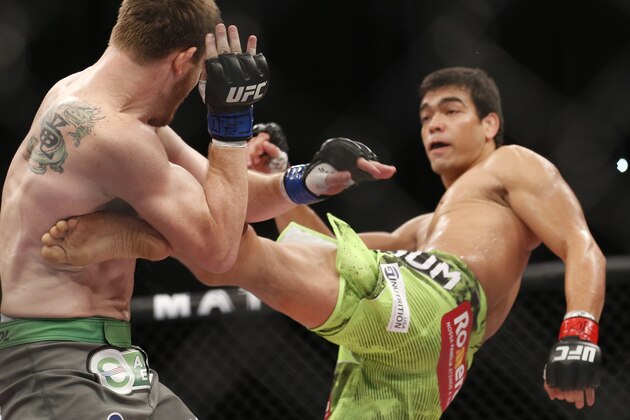 Lyoto Machida, right, from Brazil, fights CB Dollaway, from the United States, during their UFB middleweight mixed martial arts bout in Barueri, on the outskirt of Sao Paulo, Brazil, early Sunday, Dec. 21, 2014. (AP Photo/Andre Penner)