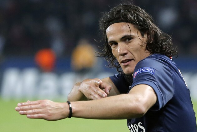 PSG's Edinson Cavani celebrates his opening goal during the Champions League Group F soccer match between Paris Saint Germain and Ajax at Parc des Princes stadium in Paris, France, Tuesday, Nov. 25, 2014. (AP Photo/Francois Mori)
