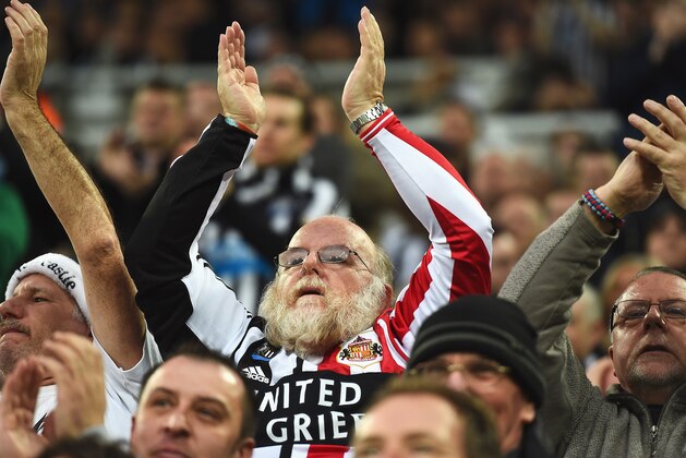 NEWCASTLE UPON TYNE, ENGLAND - DECEMBER 21:  A fan supporting both teams applauds during the Barclays Premier League match between Newcastle United and Sunderland at St James' Park on December 21, 2014 in Newcastle upon Tyne, England.  (Photo by Laurence Griffiths/Getty Images)