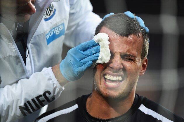 NEWCASTLE UPON TYNE, ENGLAND - DECEMBER 21:  Steven Taylor of Newcastle United receives treatment after colliding with the post during the Barclays Premier League match between Newcastle United and Sunderland at St James' Park on December 21, 2014 in Newcastle upon Tyne, England.  (Photo by Laurence Griffiths/Getty Images)