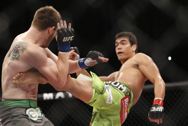 Lyoto Machida, right, from Brazil, fights CB Dollaway, from the United States, during their UFB middleweight mixed martial arts bout in Barueri, on the outskirt of Sao Paulo, Brazil, early Sunday, Dec. 21, 2014. (AP Photo/Andre Penner)