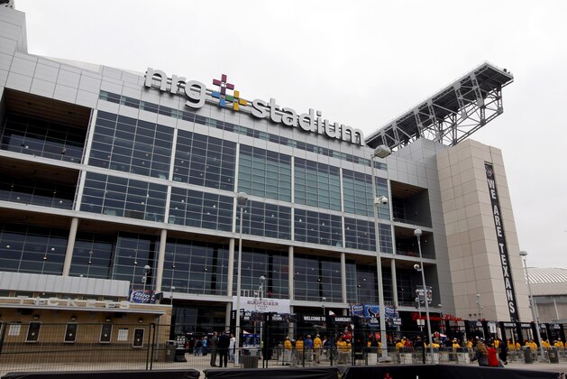Fans enter NRG Stadium before an NFL football game between the Houston Texans and the Baltimore Ravens Sunday, Dec. 21, 2014, in Houston. (AP Photo/Patric Schneider)