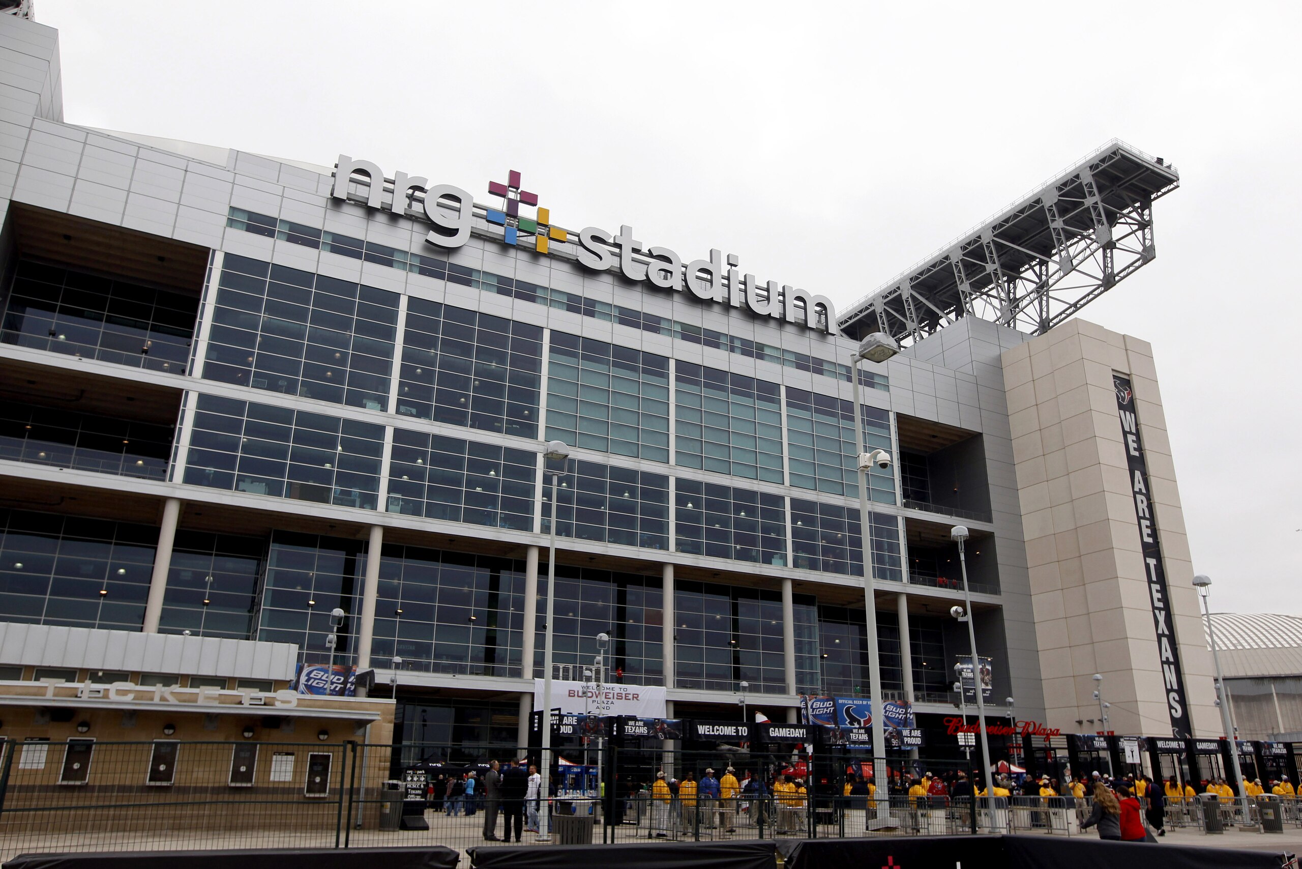 Fans enter NRG Stadium before an NFL football game between the Houston Texans and the Baltimore Ravens Sunday, Dec. 21, 2014, in Houston. (AP Photo/Patric Schneider)