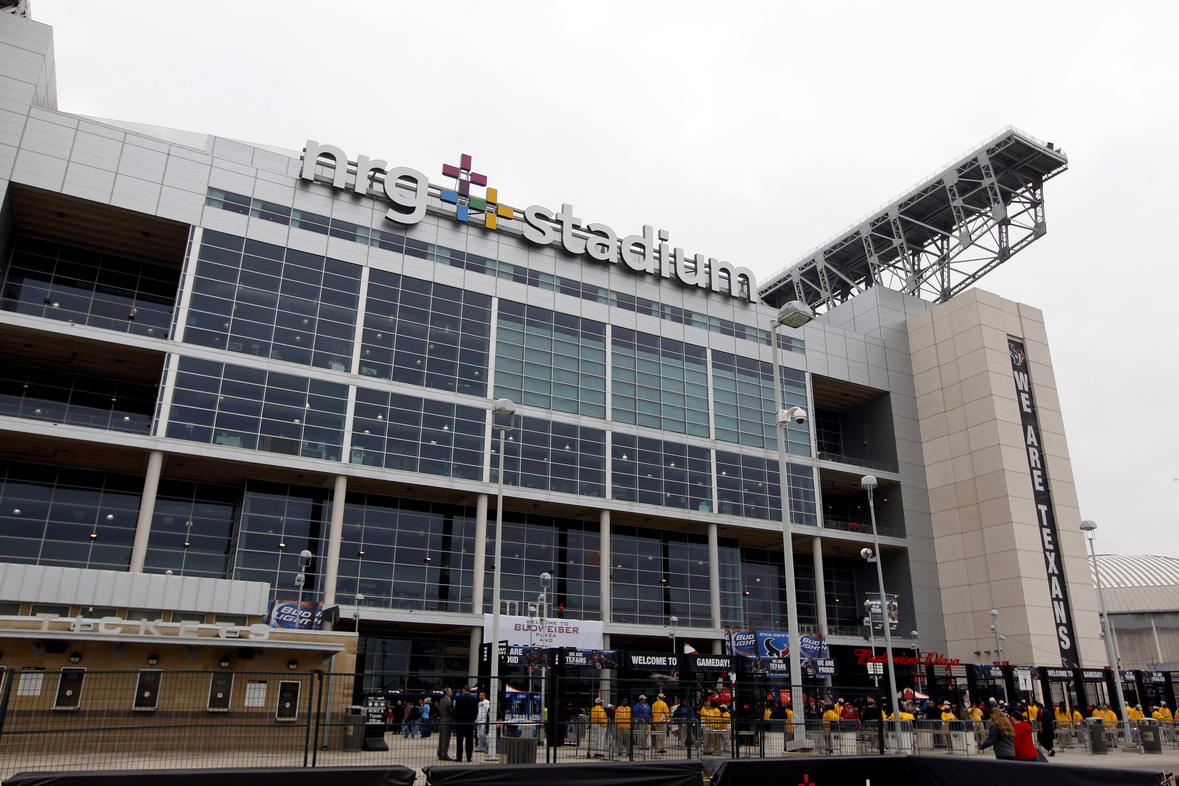 Fans enter NRG Stadium before an NFL football game between the Houston Texans and the Baltimore Ravens Sunday, Dec. 21, 2014, in Houston. (AP Photo/Patric Schneider)