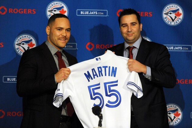 Nov 20, 2014; Toronto, Ontario, CAN;  Toronto Blue Jays catcher Russell Martin (left) receives his jersey from general manager Alex Anthopoulos after being introduced at a press conference at Rogers Centre. Mandatory Credit: Dan Hamilton-USA TODAY Sports