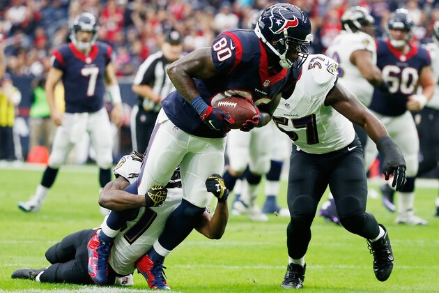 HOUSTON, TX - DECEMBER 21:   Andre Johnson #80 of the Houston Texans is tackled by Lardarius Webb #21 and  C.J. Mosley #57 of the Baltimore Ravens during the game at NRG Stadium on December 21, 2014 in Houston, Texas.  (Photo by Scott Halleran/Getty Images)