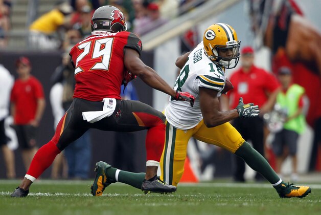 Dec 21, 2014; Tampa, FL, USA; Green Bay Packers wide receiver Randall Cobb (18) runs with the ball as Tampa Bay Buccaneers cornerback Leonard Johnson (29) defends during the first half at Raymond James Stadium. Mandatory Credit: Kim Klement-USA TODAY Sports