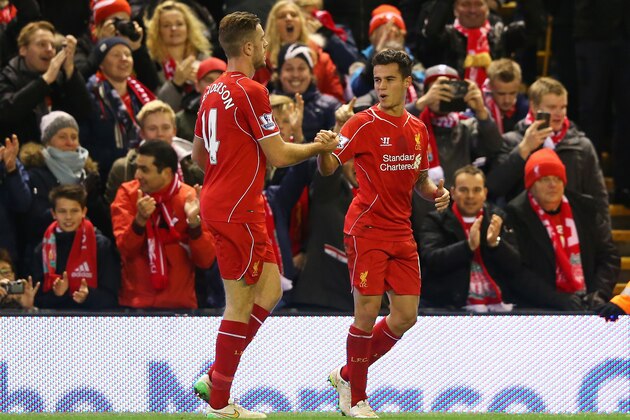 LIVERPOOL, ENGLAND - DECEMBER 21:  Philippe Coutinho (R) of Liverpool celebrates his goal with Jordan Henderson of Liverpool during the Barclays Premier League match between Liverpool and Arsenal at Anfield on December 21, 2014 in Liverpool, England.  (Photo by Alex Livesey/Getty Images)