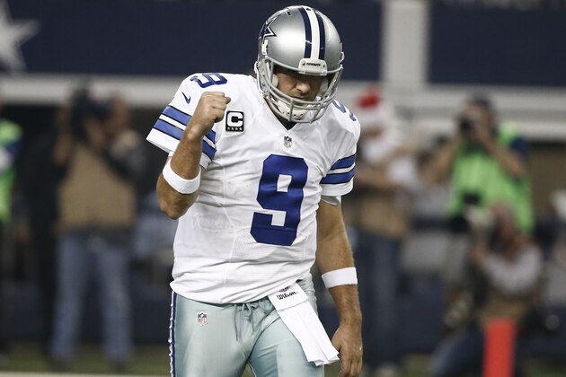 Dallas Cowboys quarterback Tony Romo (9) celebrates a touchdown pass to Cole Beasley during the first half of an NFL football game against the Indianapolis Colts, Sunday, Dec. 21, 2014, in Arlington, Texas. (AP Photo/Brandon Wade)