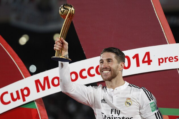 Real Madrid’s Sergio Ramos, who scored the team's first goal, holds the trophy after winning the final soccer match between Real Madrid and San Lorenzo at the Club World Cup soccer tournament in Marrakech, Morocco, Saturday, Dec. 20, 2014. (AP Photo/Christophe Ena)