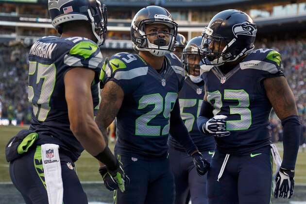 SEATTLE, WA - DECEMBER 14: (L to R) outside linebacker Mike Morgan #57 of the Seattle Seahawks celebrates with free safety Earl Thomas #29 and strong safety Jeron Johnson #23 of the Seattle Seahawks after Thomas made a play on a kick return during the third quarter of the game against the San Francisco 49ers at CenturyLink Field on December 14, 2014 in Seattle, Washington.  (Photo by Otto Greule Jr/Getty Images)