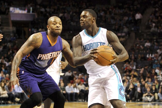 Dec 17, 2014; Charlotte, NC, USA; Charlotte Hornets guard Lance Stephenson (1) drives past Phoenix Suns forward P.J. Tucker (17) during the second half of the game at Time Warner Cable Arena. The Suns win 111-106. Mandatory Credit: Sam Sharpe-USA TODAY Sports