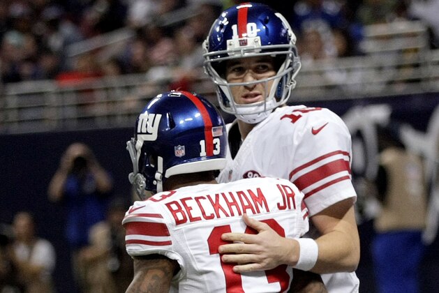 New York Giants quarterback Eli Manning, right, congratulates wide receiver Odell Beckham Jr. after throwing a 9-yard touchdown pass to Beckham during the first half of an NFL football game against the St. Louis Rams Sunday, Dec. 21, 2014, in St. Louis. (AP Photo/Tom Gannam)