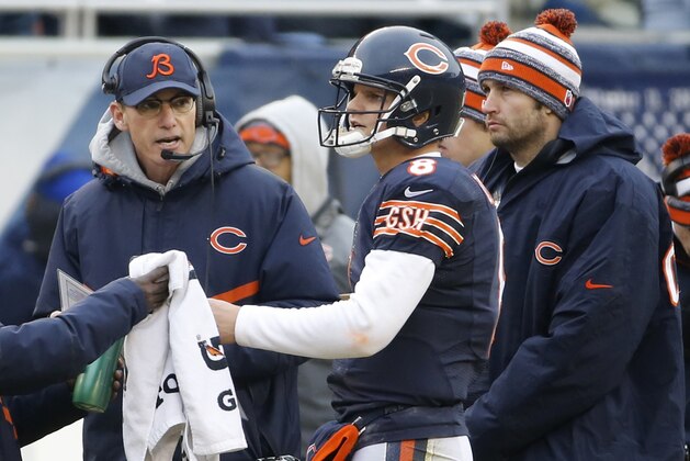 Chicago Bears head coach Marc Trestman, left, talks to quarterback Jimmy Clausen (8) as Jay Cutler, right, looks on in the first half of an NFL football game against the Detroit Lions Sunday, Dec. 21, 2014, in Chicago. (AP Photo/Charles Rex Arbogast)