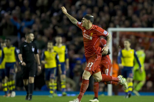Liverpool's Martin Skrtel, centre right, celebrates after scoring a late goal against Arsenal during the English Premier League soccer match between Liverpool and Arsenal at Anfield Stadium, Liverpool, England, Sunday Dec. 21, 2014. (AP Photo/Jon Super)