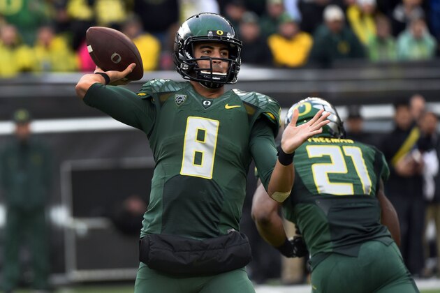Oregon quarterback Marcus Mariota (8) passes the ball during the second quarter of an NCAA college football game against the Colorado on Saturday, Nov. 22, 2014, in Eugene, Ore. (AP Photo/Steve Dykes)