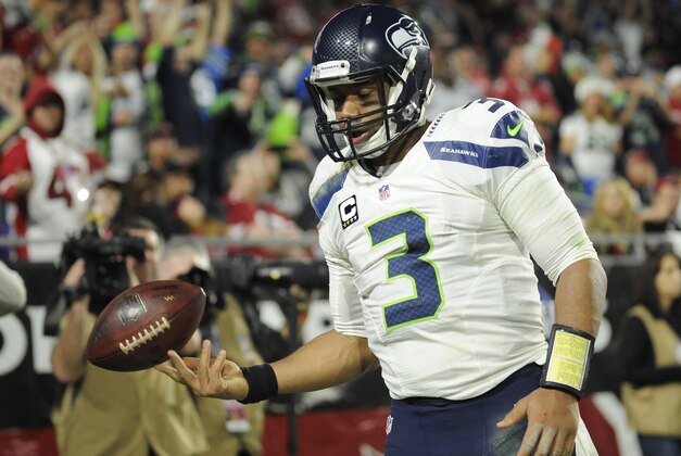 Dec 21, 2014; Glendale, AZ, USA; Seattle Seahawks quarterback Russell Wilson (3) celebrates a touchdown during the second half against the Arizona Cardinals at University of Phoenix Stadium. The Seahawks won 35-6. Mandatory Credit: Joe Camporeale-USA TODAY Sports