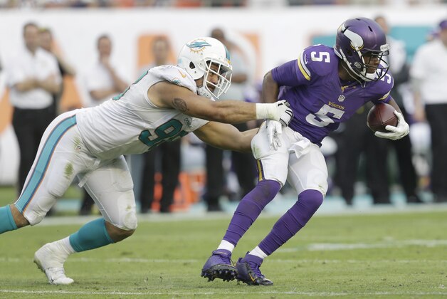 Miami Dolphins defensive tackle Jared Odrick (98) sacks Minnesota Vikings quarterback Teddy Bridgewater (5) during the second half of an NFL football game, Sunday, Dec. 21, 2014 in Miami Gardens, Fla. The Dolphins defeated the Vikings 37-35. (AP Photo/Wilfredo Lee)