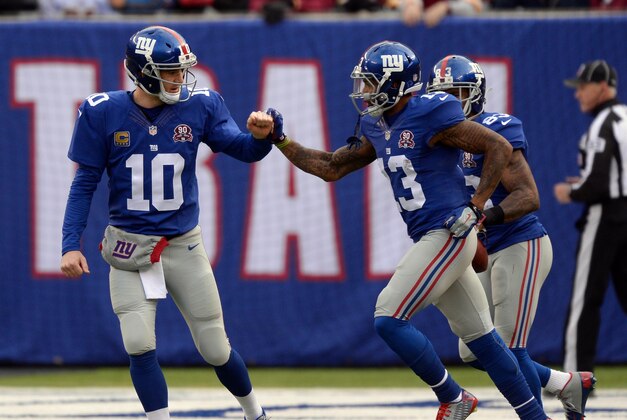 Dec 14, 2014; East Rutherford, NJ, USA; New York Giants quarterback Eli Manning (10) greets New York Giants wide receiver Odell Beckham (13) after Beckham's touchdown against the Washington Redskins at MetLife Stadium. Mandatory Credit: Robert Deutsch-USA TODAY Sports