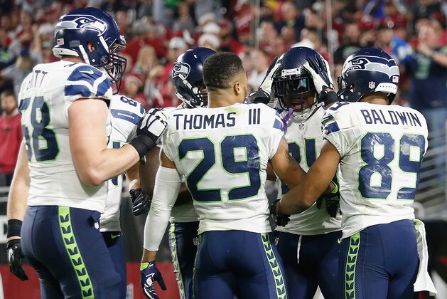 GLENDALE, AZ - DECEMBER 21:  Running back Marshawn Lynch #24 of the Seattle Seahawks celebrates with teammates after scoring a 79 yard touchdown in the fourth quarter during the NFL game against the Arizona Cardinals at the University of Phoenix Stadium on December 21, 2014 in Glendale, Arizona.  (Photo by Christian Petersen/Getty Images)