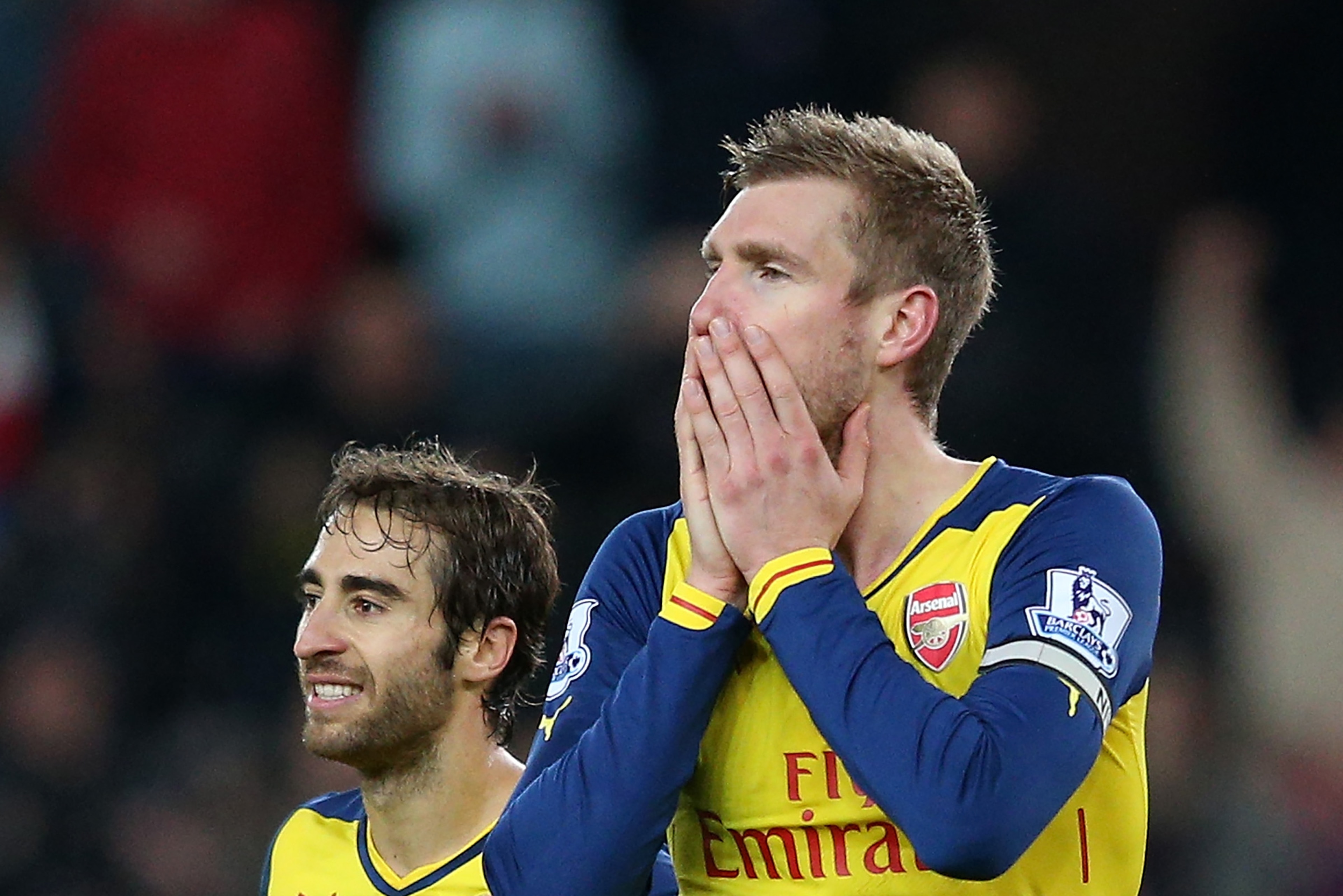 STOKE ON TRENT, ENGLAND - DECEMBER 06:  Mathieu Flamini (L) and Per Mertesacker of Arsenal react after Calum Chambers of Arsenal is shown a red card by Referee Anthony Taylor during the Barclays Premier League match between Stoke City and Arsenal  at the Britannia Stadium on December 6, 2014 in Stoke on Trent, England.  (Photo by Clive Mason/Getty Images)